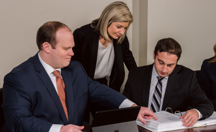 the attorneys of Miller & Tischler working in their office