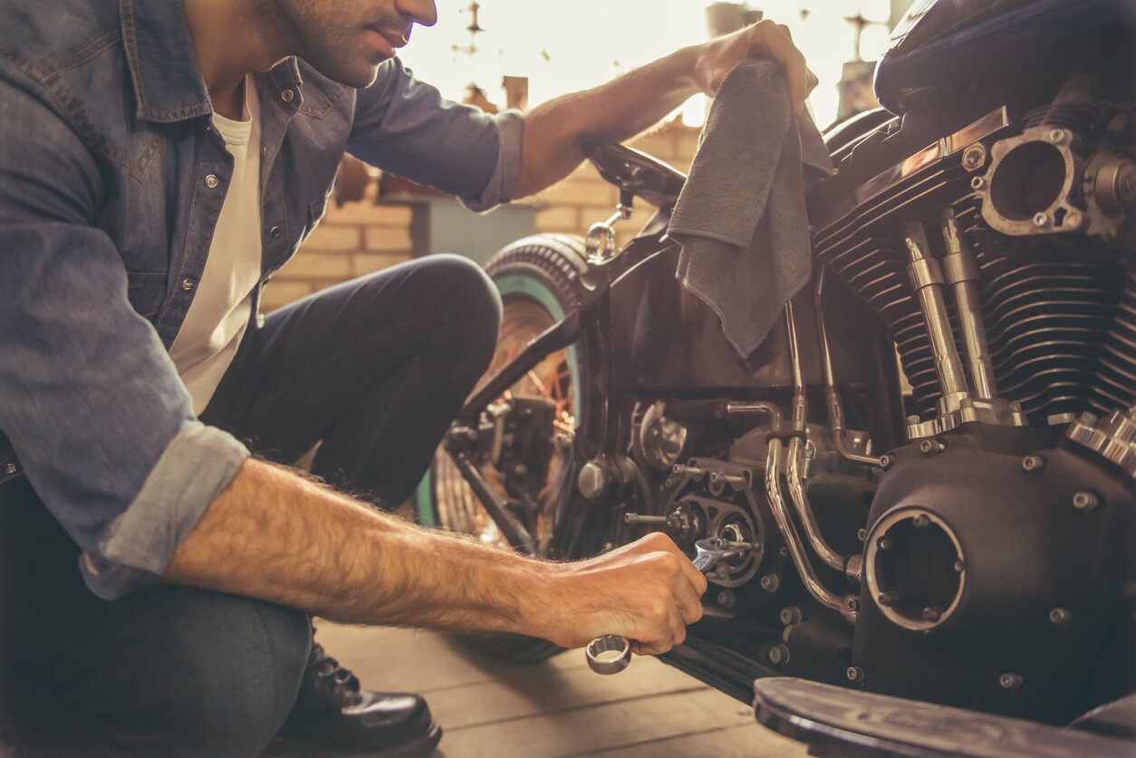 guy taking care of motorcycle