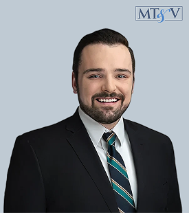 Professional headshot of a smiling man in a dark suit and striped tie against a light blue background; MTSV logo in the upper-right corner. Andrew_B  Miller, Tischler & Vislosky, P.C. Andrew_B  Miller, Tischler & Vislosky, P.C.